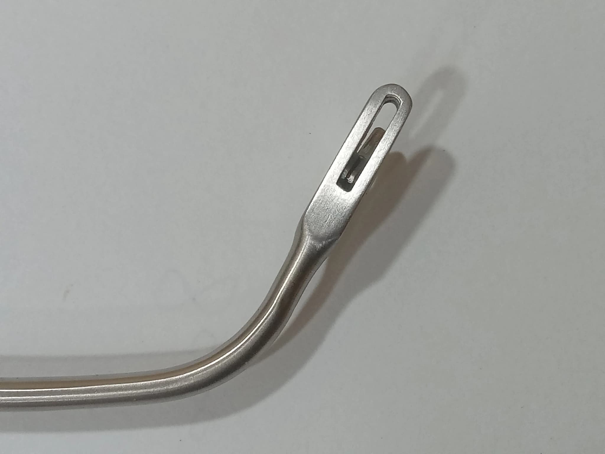 Curved metal instrument tip