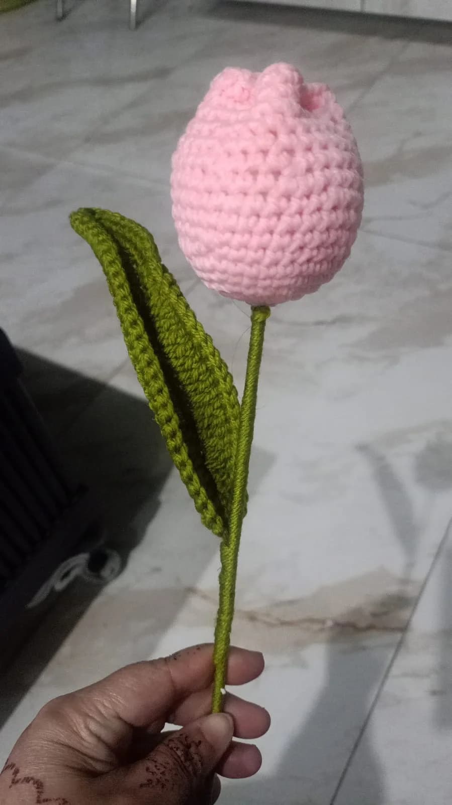pink crocheted tulip with green stem