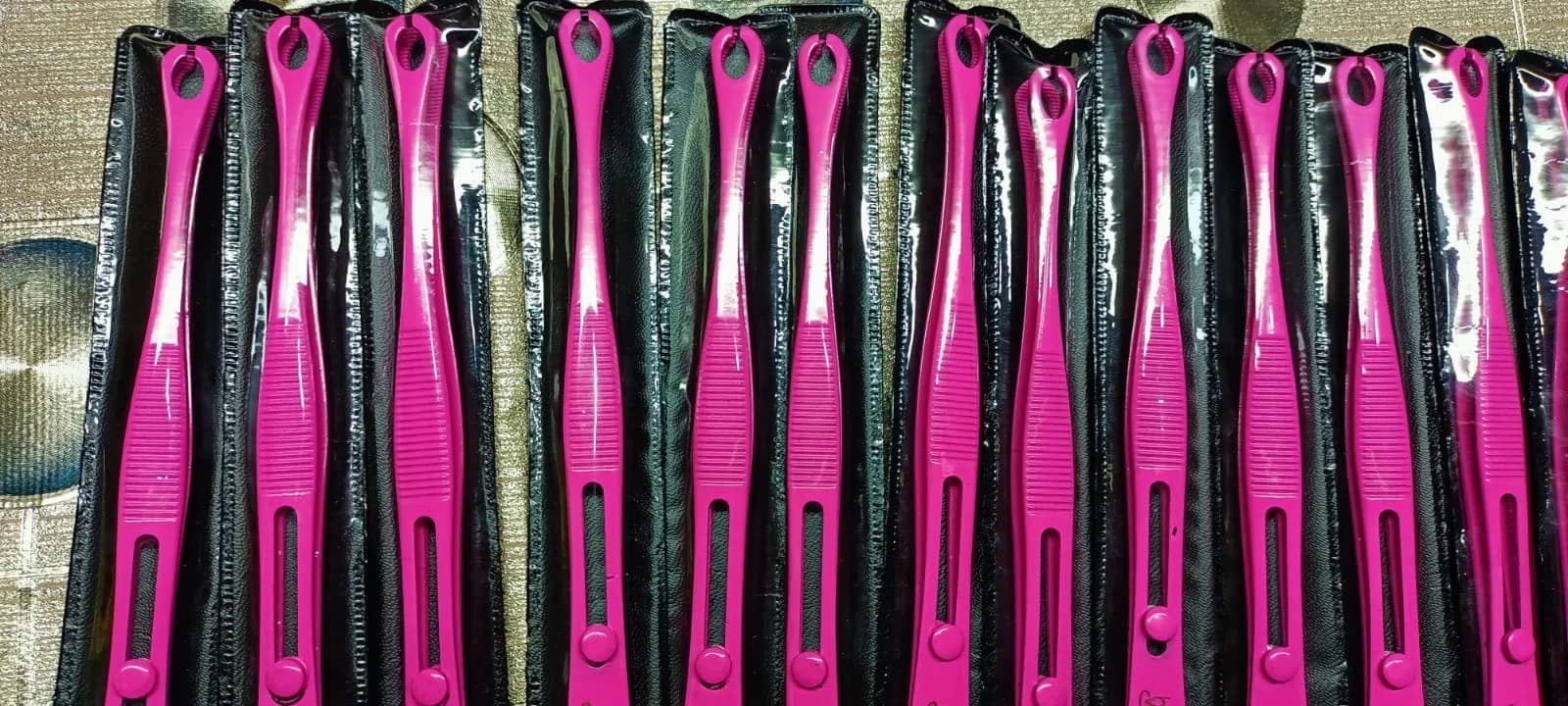 Pink piercing forceps